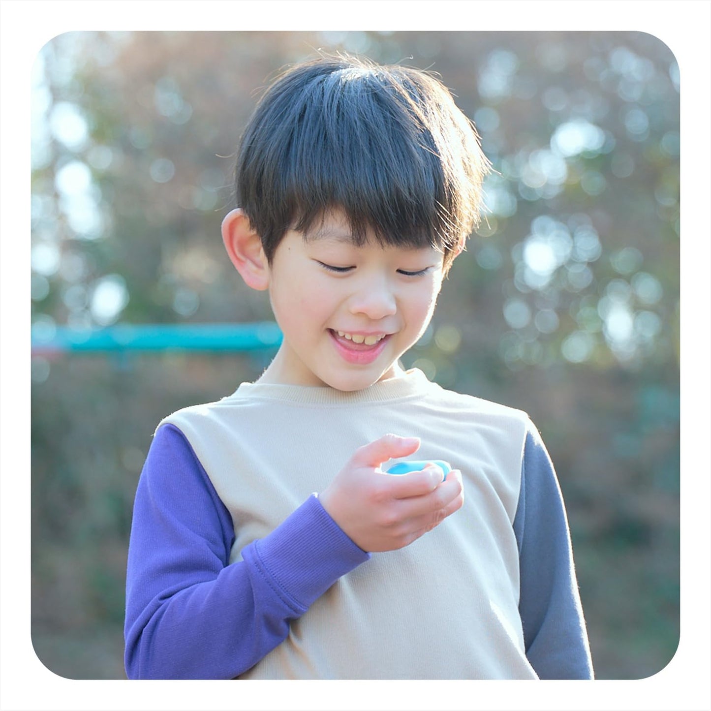 Boy holding BoT Talk device with silicone case
